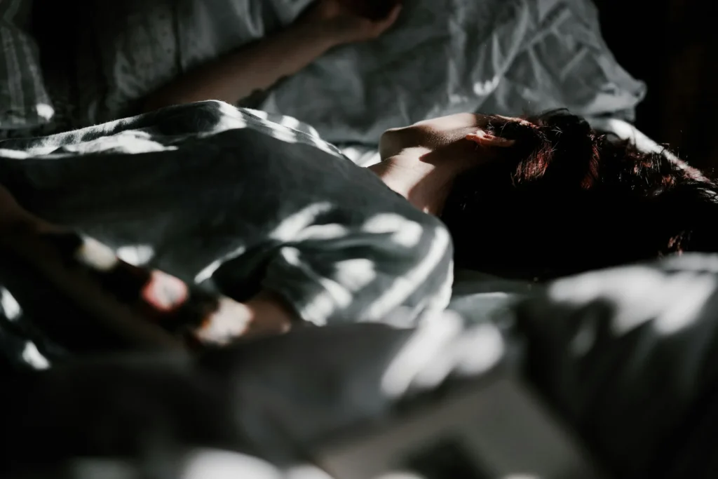Exhausted person lying in bed