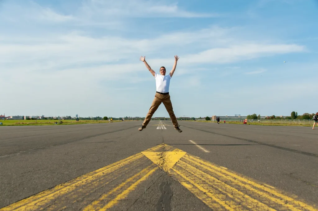 Person jumping on an empty road