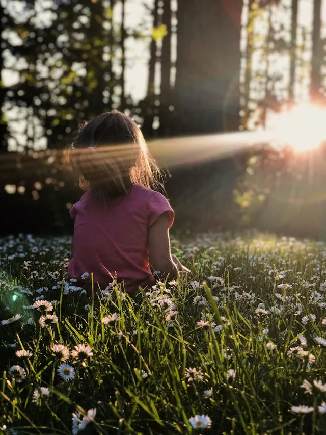 Child in a garden at sunset