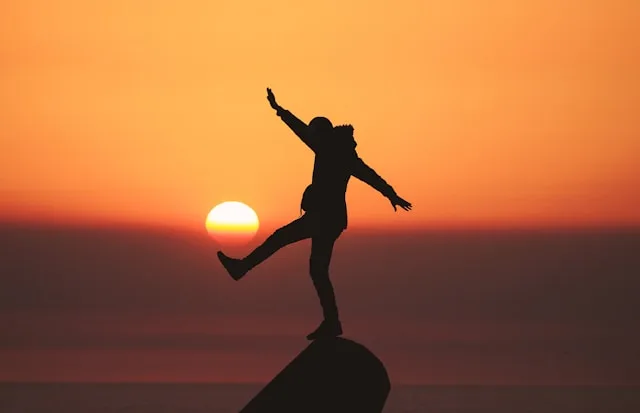 Silhouette balancing at sunset